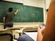 Man writing on chalk board